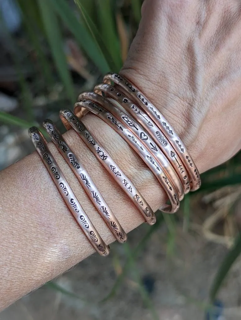 Copper cuff bracelets with stars and Thunderbird arrows